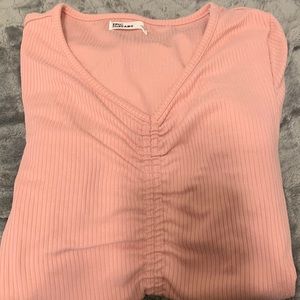 Long sleeve pink shirt.